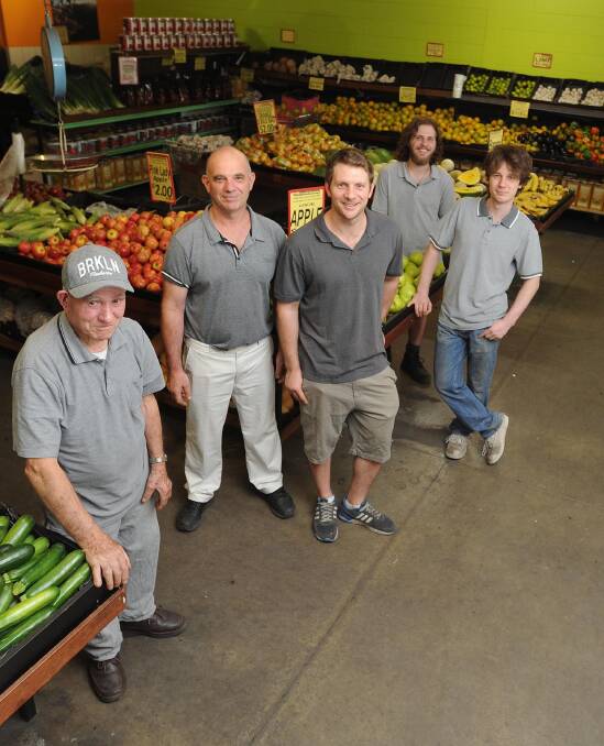 Roots in fruit: Wagga Fruit Supply founder Angelo Papasidero with son Robert Papasidero and grandsons Steve, Nicholas and Jonathan. Picture: Laura Hardwick 