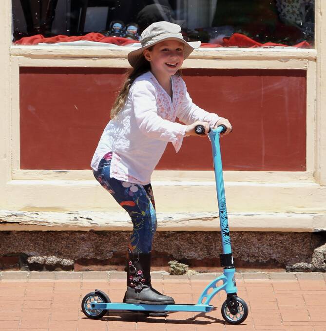 ALL SMILES: The Rock resident Grace Julilan, 6, scoots around the Rock or Bust music festival at the weekend. Picture: Les Smith