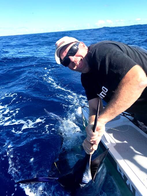 HAPPY DAYS: Ben Jones with a striped marlin of the Ulladulla coastline. Send pictures to craig@waggamarine.com.au or 0419 493 313. 