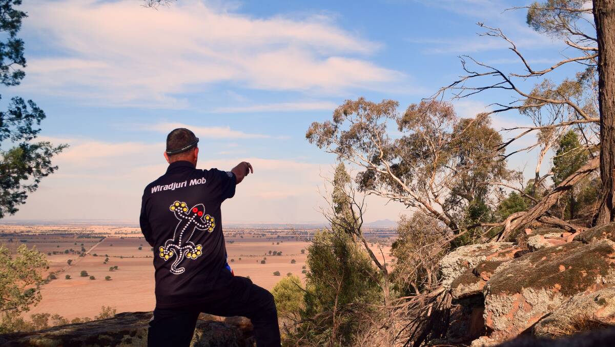 SONGLINE: Mark Saddler points toward Kengal (The Rock) on one of his cultural tours. The theme for NAIDOC week this year is songlines. Picture: Mark Saddler
