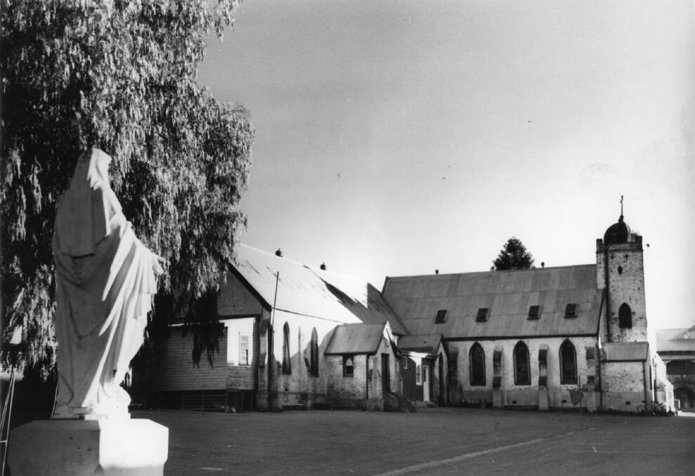 PAST: ​The original St Michael’s Church was built was built in 1859 and was later used as part of the Christian Brothers School established in 1914. Contact www.wwdhs.org.au. Picture: CSURA RW1574_653