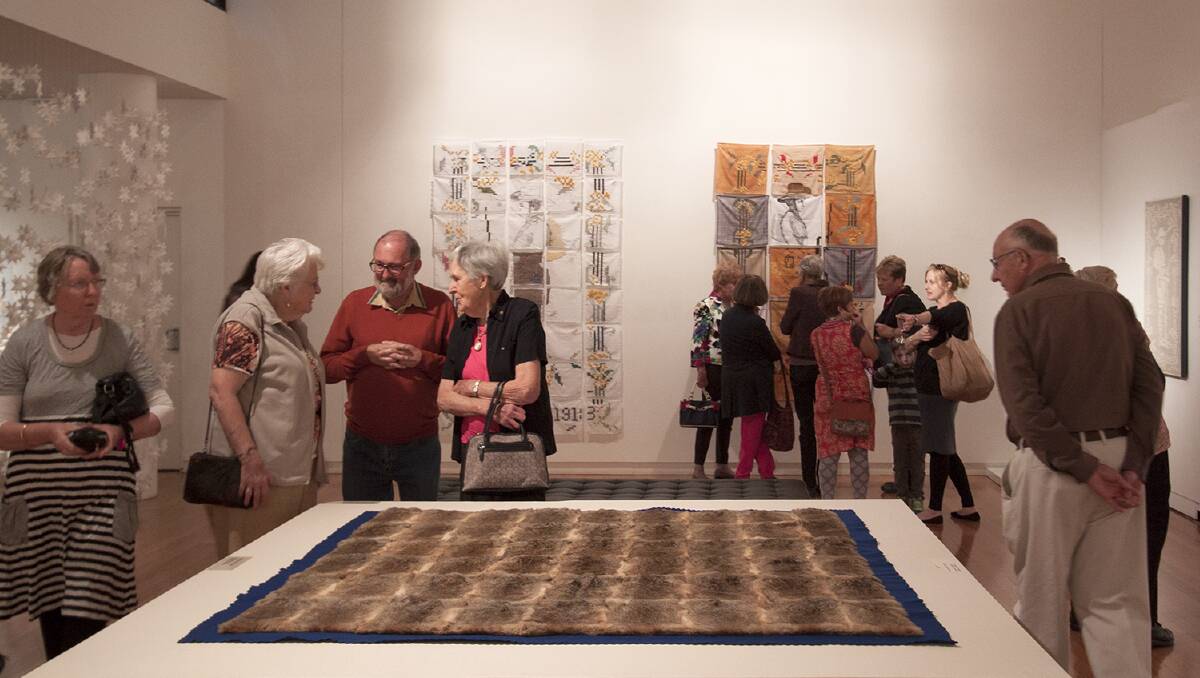 HISTORY: Patrons enjoying works from the exhibition Loss, reverence and longing: Anzac stories from the Home Front. Picture: Contributed