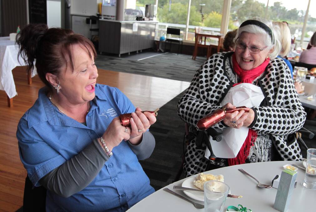 FESTIVE: Sharon Bryon and Jan Stratton get jolly at the Forrest Community Services Christmas in July at the Wagga Boat Club on Wednesday. Picture: Les Smith