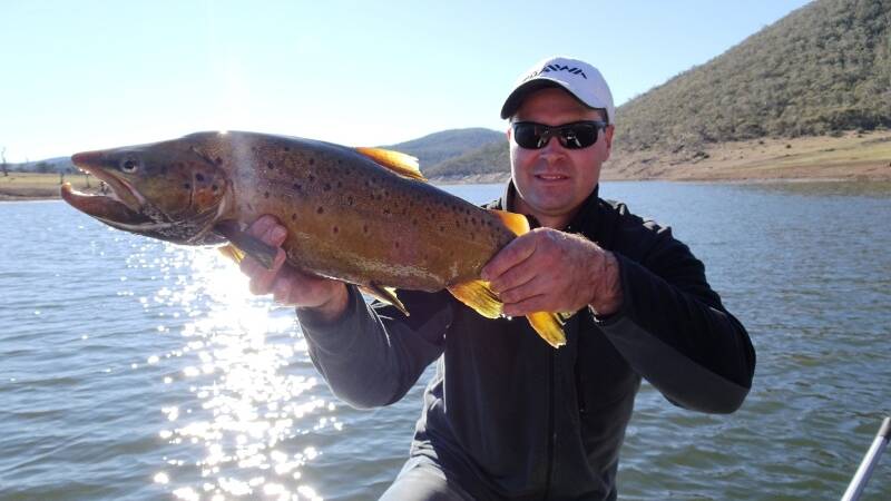 ALL MINE: Col Robinson with a brown trout caught at Eucumbene. Picture: Contributed