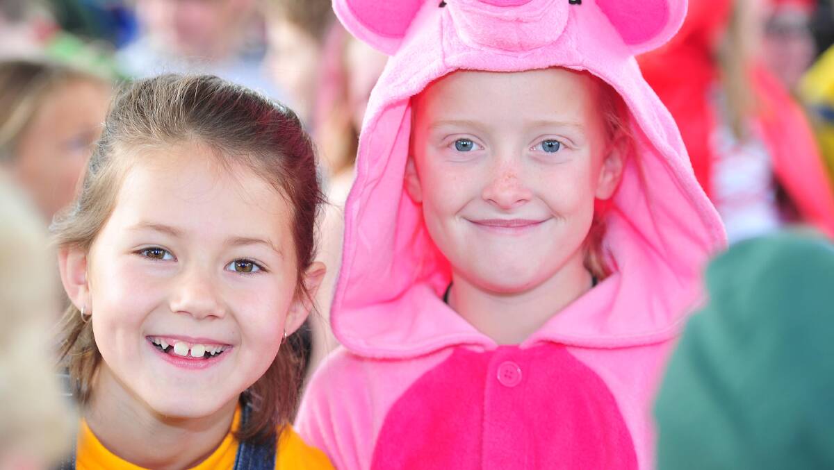 BANANAS AND BACON: Emmy McMahon as a minion and Millie Chisolm in a piggy costume at North Wagga Public School's book week dress-up day. Picture: Kieren L Tilly