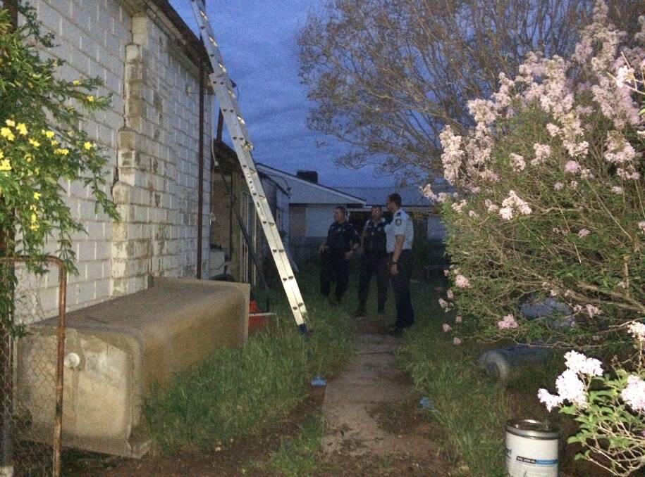BOMB WAIT: Wagga and Temora Police wait for the Sydney Bomb Squad to arrive at this Langham Street house in Ganmain, hours later than expected. Picture: Marguerite McKinnon