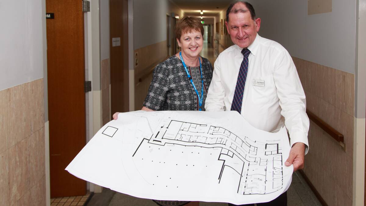 New look: Mercy Health's Chris Arnold and Albury Wodonga Health's Russel Sheppard with plans for the brain centre. Picture: SIMON BAYLISS
