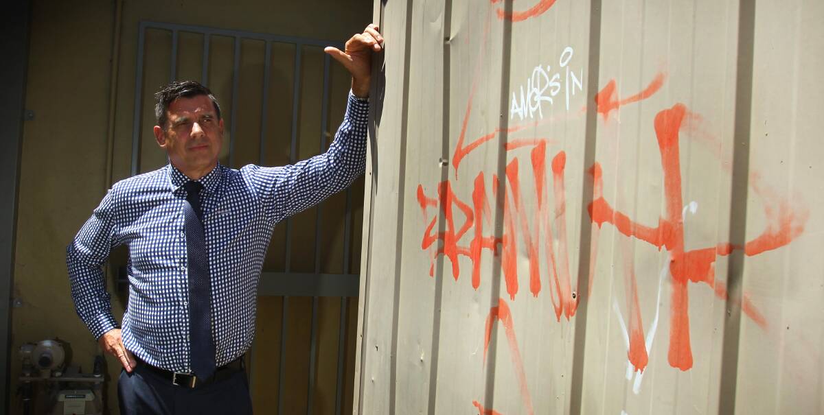 DISAPPOINTED: The Actions Awareness Group publicity officer Paul Gooden inspects graffiti tags scrawled on the side of a shed at Wagga Beach on Monday. Picture: Les Smith