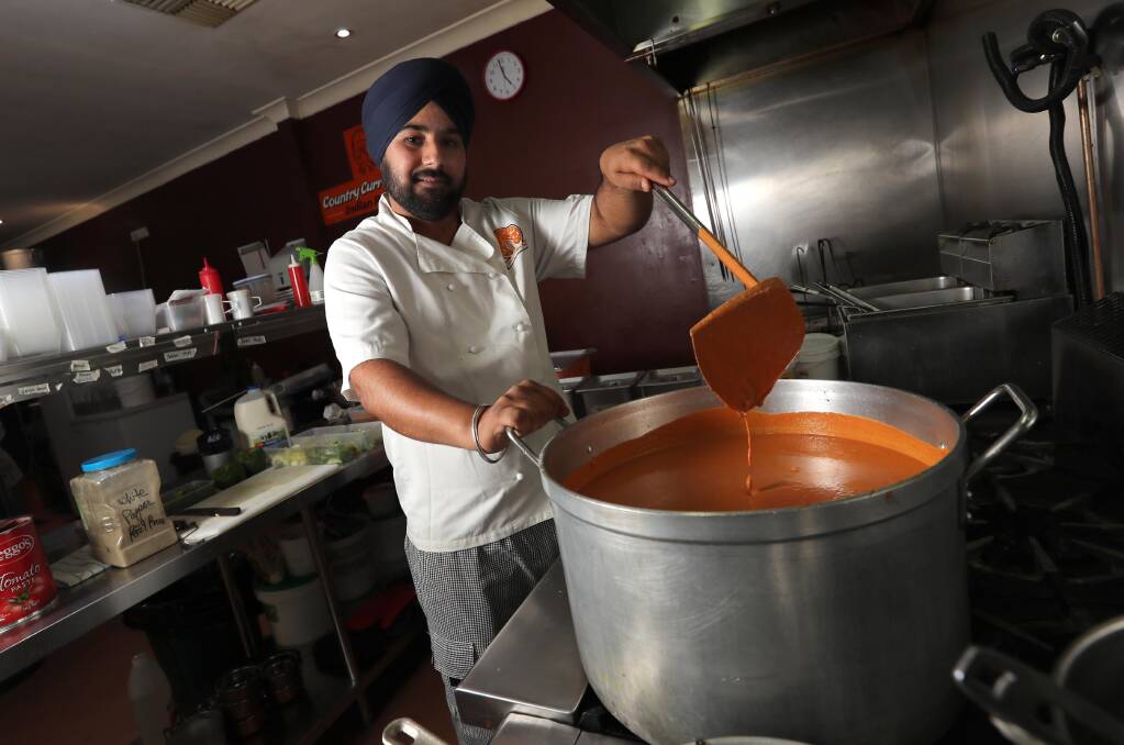INDIAN CUISINE: Harcharan Singh prepares the butter chicken sauce. He will be helping in the effort to cook this Saturday. Picture: Les Smith 