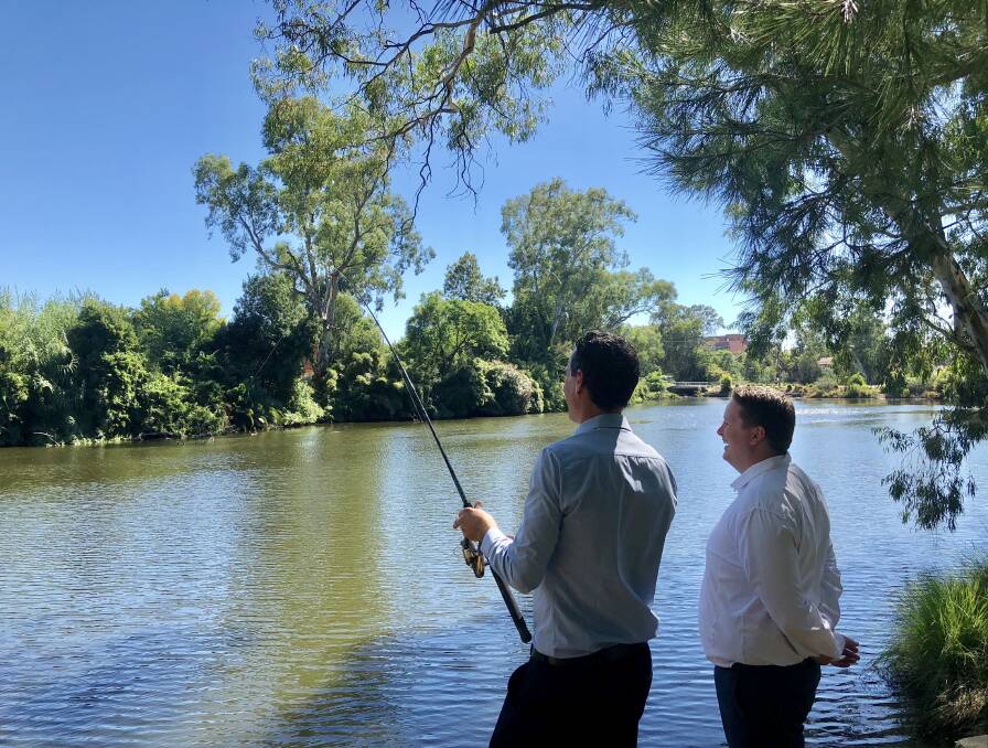 TESTING THE WATERS: Mathew Longmore and Josh Paul have found an ideal spot and exchange ideas on the best way to fish. Picture: Annie Lewis 