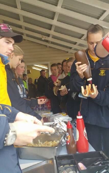 HELPING HAND: Yanco Agricultural High School students tuck into a barbecue to raise funds for Leeton High School's project to honour Stephanie Scott. 
