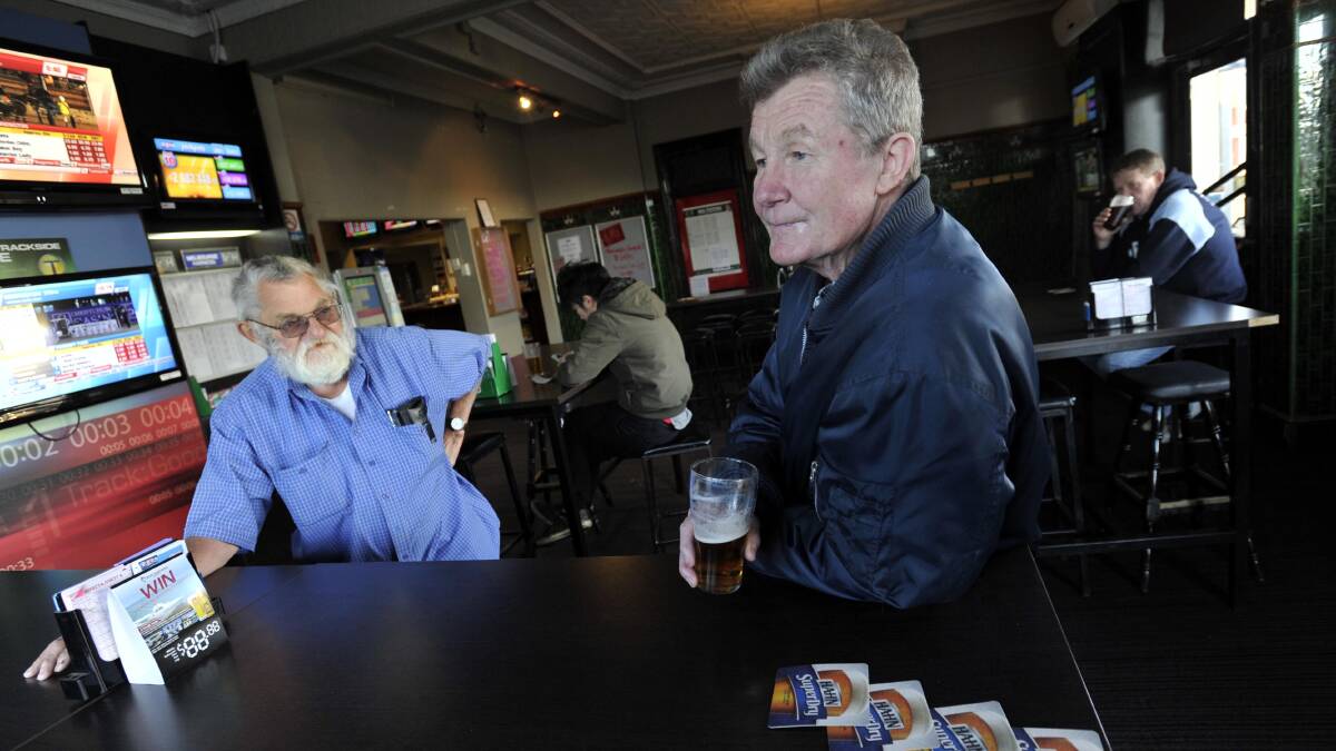 Billy Hackett with Merv Hall at Junee's Commercial Hotel. Picture: Les Smith