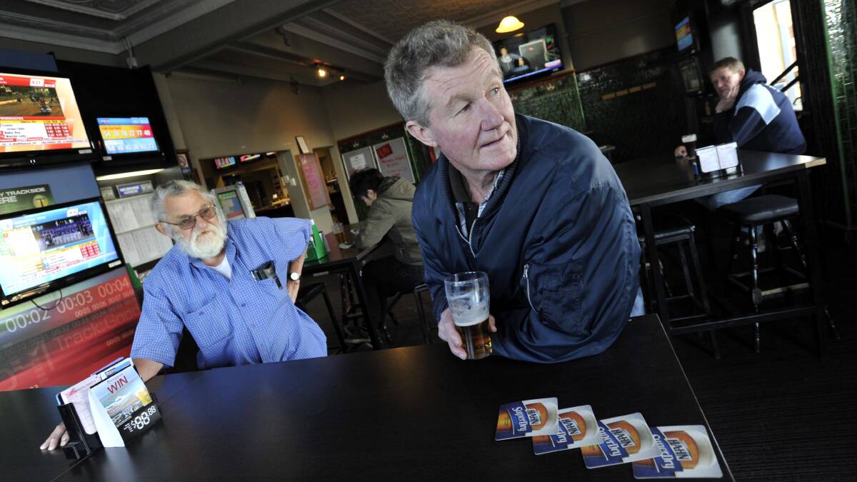 GIRL DROUGHT: Merv Hall (left) and Billy Hackett lament the fact men outnumber women in Junee over beers at the Commercial Hotel. Picture: Les Smith