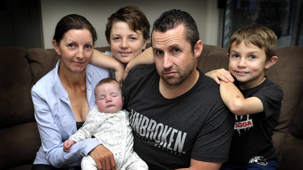 MY FIGHT: Brad Fewson at his North Wagga home with wife Laura, baby George, four months, CJ, 13, and Jack 10. Picture: Les Smith