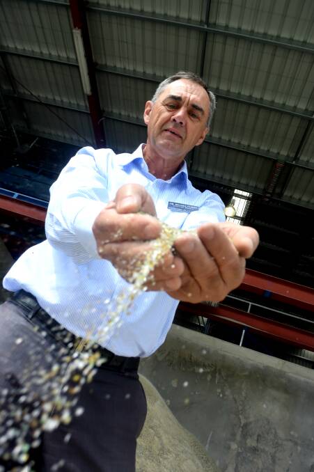 SANDS OF TIME: Kurrajong Recyclers operations manager Tim Macgillycuddy runs the finely crushed glass through his fingers at an opening of new landfill-cutting facilities on Wednesday. Picture: Brodie Owen