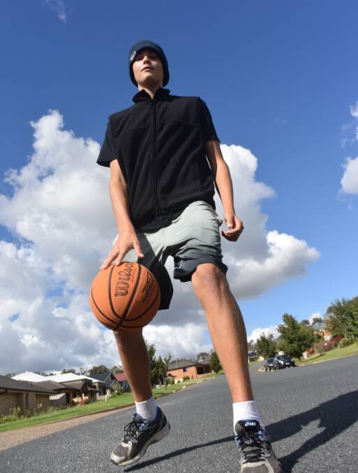 IN THE STREETS: Andrew Wright, 16, dribbles the ball on Bourkelands Drive, which was a hive of construction activity a decade ago. Picture: Brodie Owen