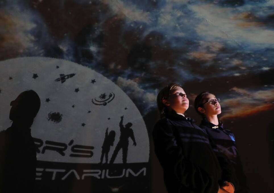 SKY HIGH: Wagga Public School students Noah McGrath, 10 and Jasmine Lewis, 11, at the pop-up planetarium in the Wagga Council Meeting Room. Picture: Les Smith
