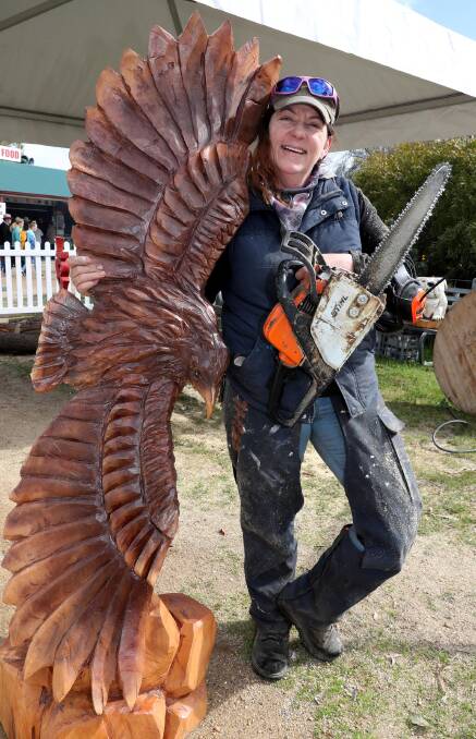 Angie Polglaze with an eagle-shaped chainsaw wood carving she created. Picture: Les Smith