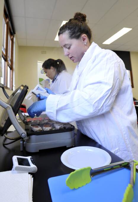 COOKING STORM: Researchers - PhD students Stephanie Fowler (front) and Gerlane Brito - cook lamb samples for taste testing. Pictures: Les Smith