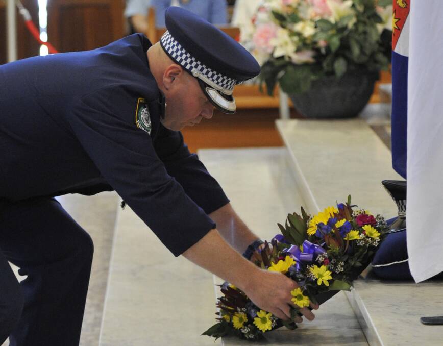 Superintendent Bob Noble lays a wreath at the National Police Rememberance Day service at St Michael's cathedral Wagga.