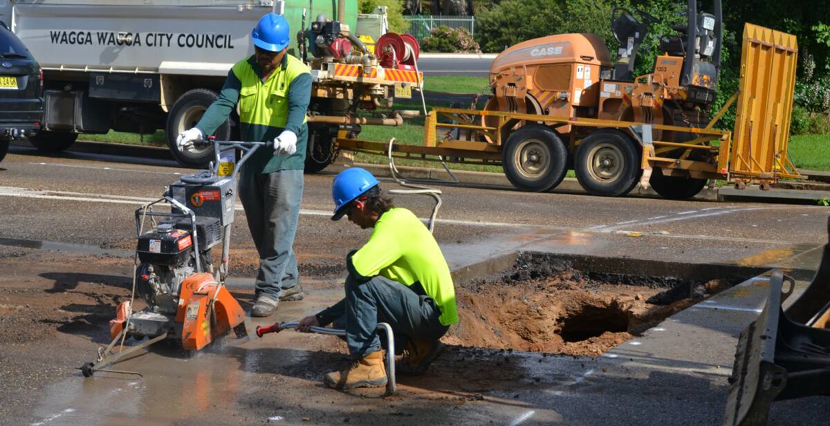 Wagga City Council works to fix a sinkhole on Kincaid Street.