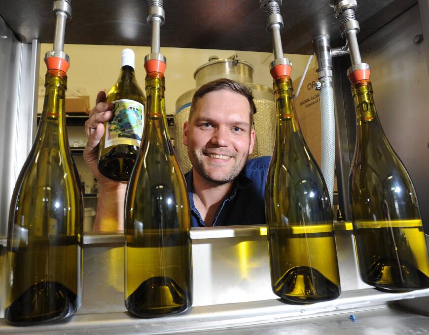 CRUSHING: Charles Sturt University winemaker Campbell Meeks with the first of the 2016 Vintage being bottled on Thursday. Picture: Laura Hardwick