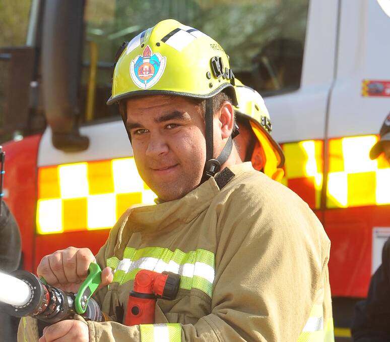 FLAME OUT: Wagga TAFE team member Jarrod Moala works the hose at a Wagga View Race challenge at the Turvey Park fire station. Picture: Kieren L Tilly