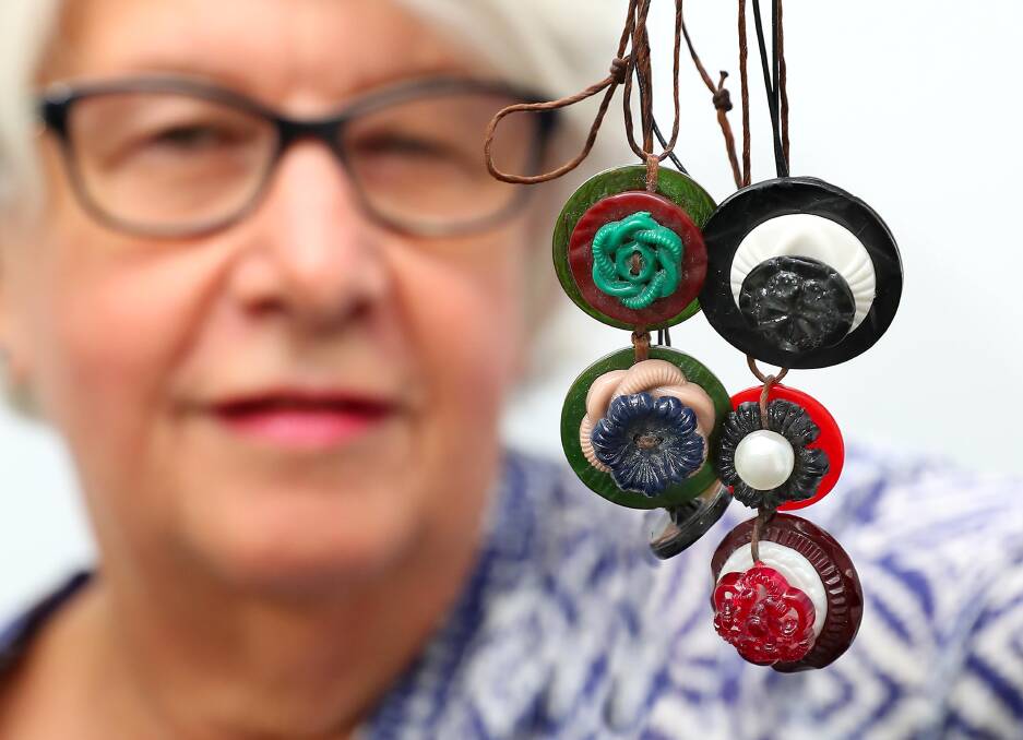 PUSHING BUTTONS: Rhonda Walmsley of the Wagga Antiques Society with some necklaces made from old buttons. Picture: Kieren L Tilly
