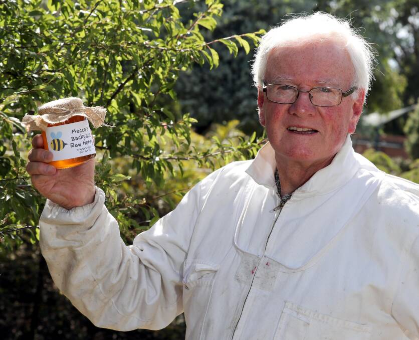 HONEY, HONEY: Wagga beekeeper Neil McMullen with some of the honey from his own hives. Mr McMullen is happy to help Wagga people if bees swarm at their homes. Picture: Les Smith