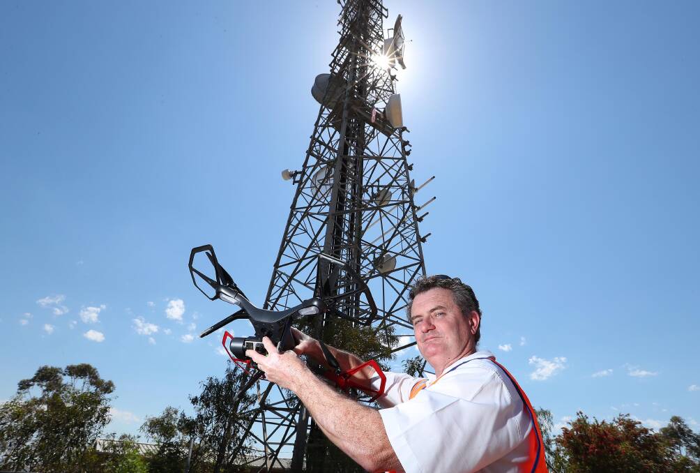 SKY-HIGH EYE: Neville Shepheard from Telstra, a CASA-licensed pilot, with his company Solo 3DR drone on top of Willans Hill. Picture Kieren L. Tilly