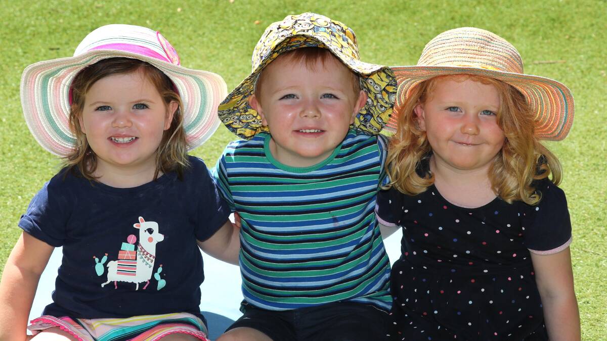SUN SAFE: Abigail O'Hare, 2, Fletcher Byron, 3, and Harriet Daly, 2, are all prepared for the sun with their broad-brimmed hats. Picture: Les Smith