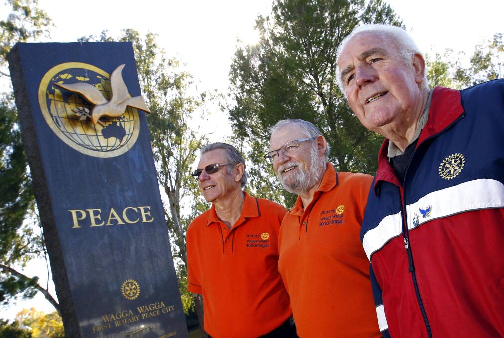 Rotarians Malcolm Nixon, Rod Francis and Fred Loneragan at the Wagga peace symbol.