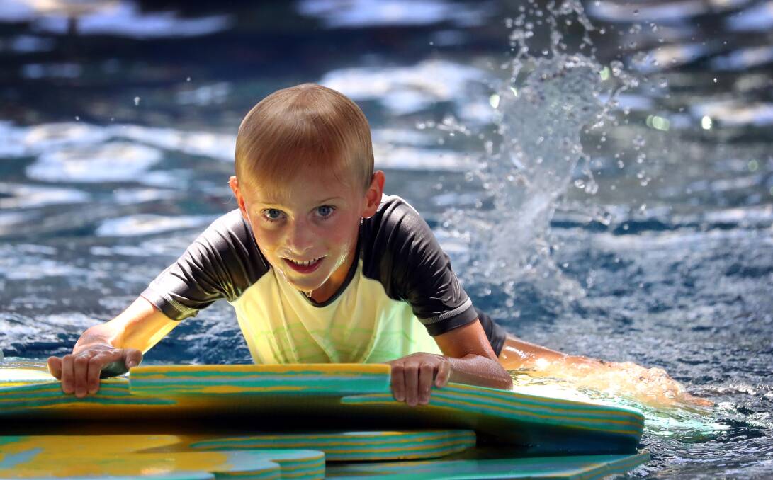 SPLASHING AROUND: Toby Owers, 6, from Wagga, escapes the heat and cools off at the Oasis Aquatic Centre. Picture: Les Smith