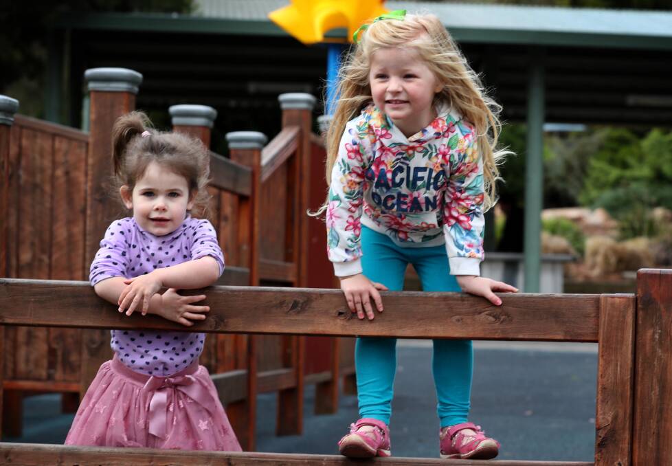 Laura Davidson, 2, and Aurelia van Zon, 3, both of Wagga, enjoyed the mild weather in the Botanic Gardens on Wednesday. Picture: Les Smith