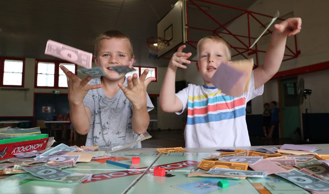 MONEY, MONEY, MONEY: Budding entrepreneurs Michael Landow, 7, and Alexander Morrison, 5, opted for a game of Monopoly. Picture: Les Smith