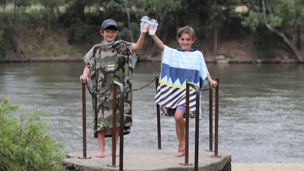 COOLING OFF: Taj Harper and his mate Finn Anderson, both aged 8, got some relief from the heat with a trip to Wagga Beach. Picture: Les Smith