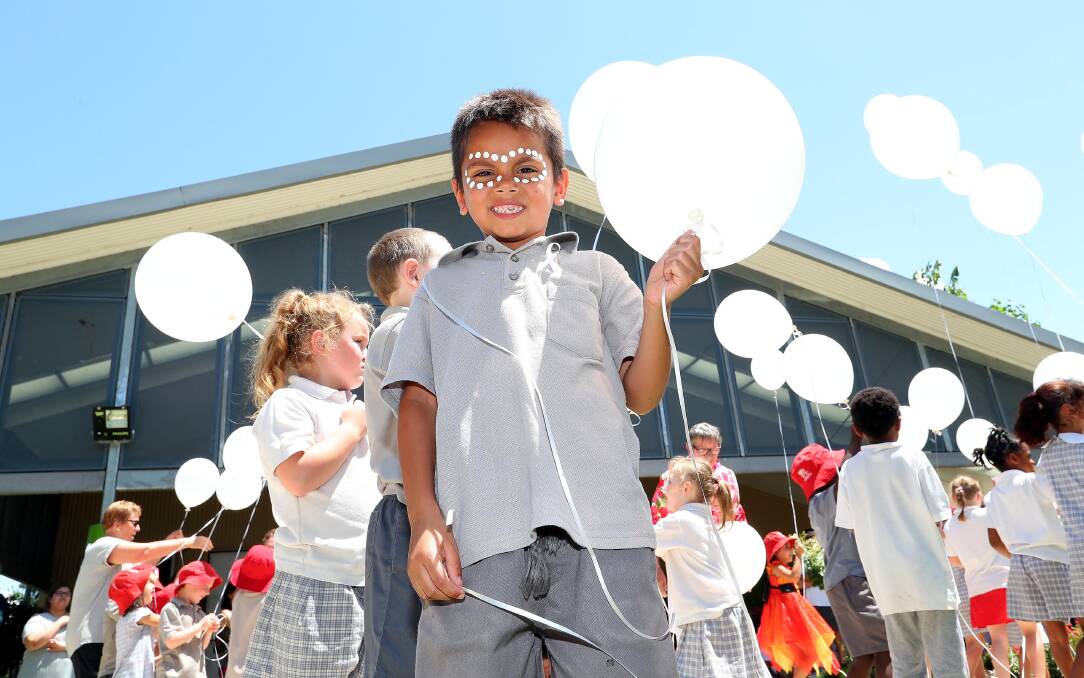 SAYING NO: Mount Austin Public School kindergarten pupil Lethan Douglas releases white balloons in recognition of White Balloon Day. Picture: Kieren L Tilly
