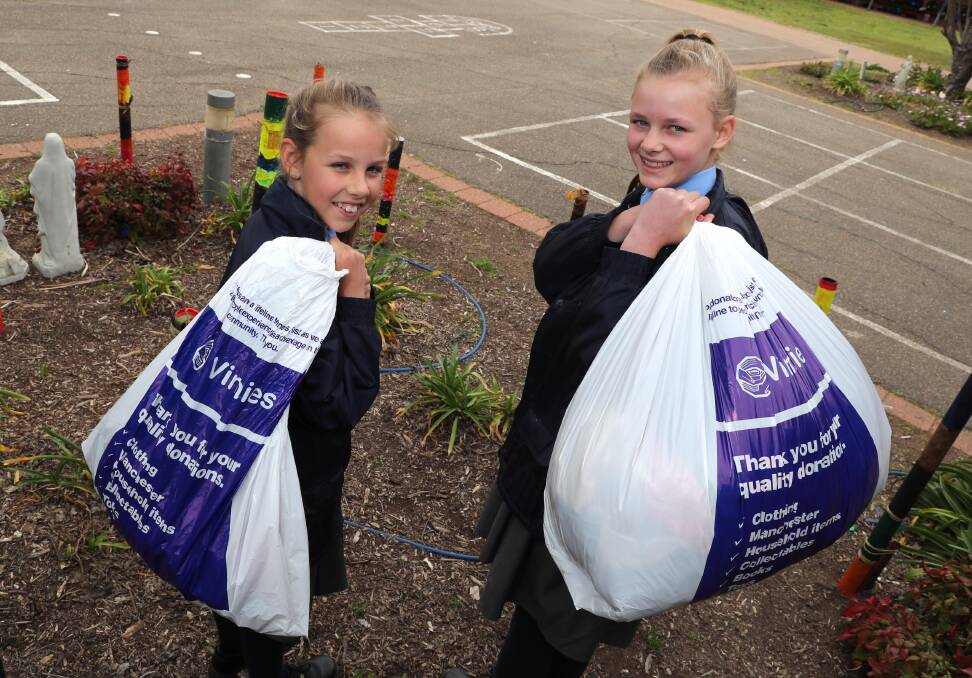 Molly McPherson, 11, and Amelia Deal, 12, are ready to help St Vincent de Paul with a clothing drive. Picture: Les Smith