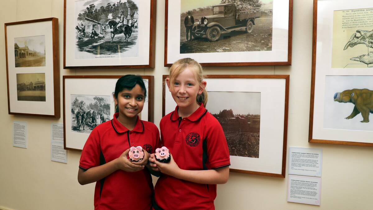 STUDENTS OF HISTORY: Nethukee Jayasekera and Clare Chapman, both 10, at the opening of the exhibition they helped curate. Picture: Les Smith