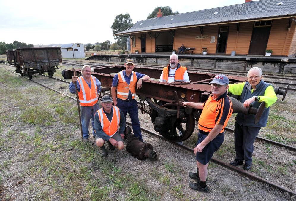 Dedicated volunteers Gordan Stewart, Wally Bell, Colin Heinzel, Don Pollard, Les Homer and Dick Goodman in 2013, outside Ladysmith railway station, with a coal wagon chassis. 