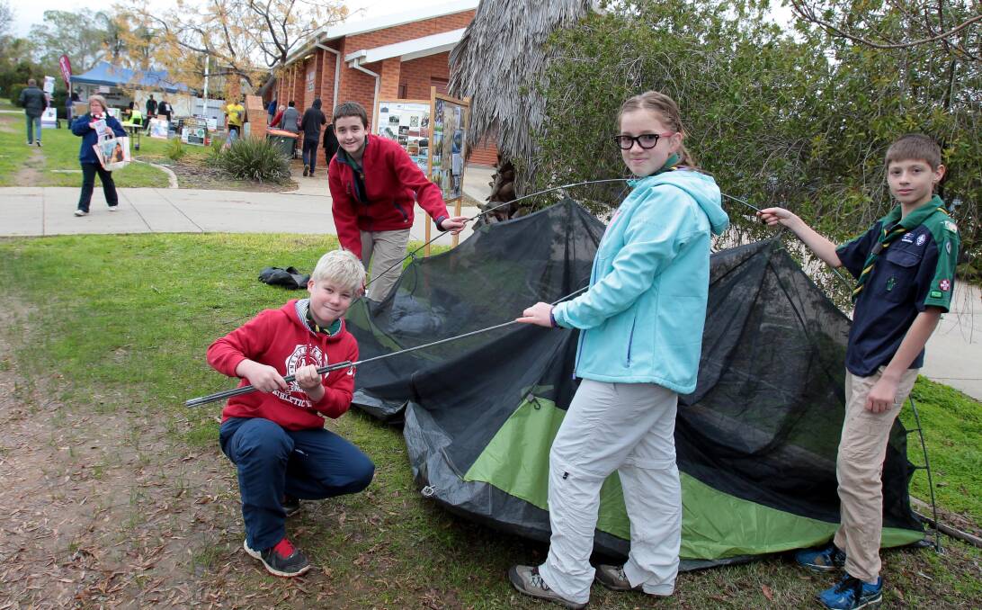 MAKING A PITCH: Local scouts Lachlan Kotzur, 12, William Meiklejohn, 13, Holly Mack, 13 and Riley Aplin, 11, erect a tent and take advantage of the voting crowds on election day. Picture: Les Smith