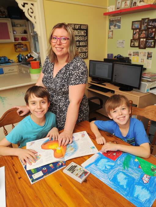 NEW WAY OF LEARNING:  Mum Laurelle Lewis with sons Christopher and Noah Forbes, undertaking a class from the comfort of their own home. 