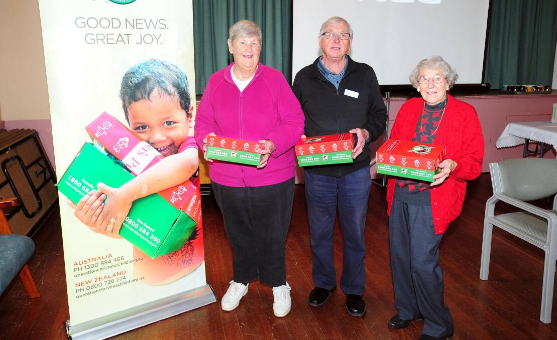 PEAK GENEROSITY: Edna Cowley, Des Cowley and Thelma Fisk are volunteering to deliver shoebox gifts to children in need. Picture: Kieren L.Tilly