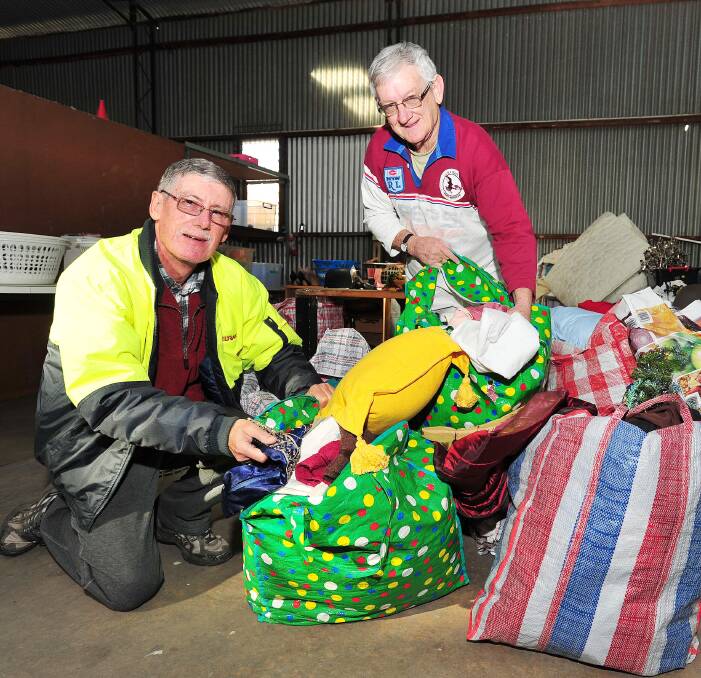 Donations: Gary Field and Phil Field, although they share a last name they aren't related, sorting through donations at the new Salvation Army store on 180 Forsyth Street. Picture: Kieren L.Tilly.