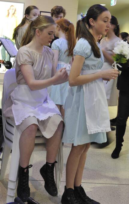 Preparation: Willow Essex helps Angelica Temponeras with her costume prior to taking the stage with the Wagga High School junior dance ensemble. Picture: Les Smith.