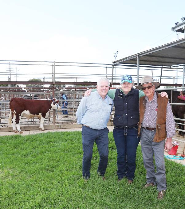 RSL general manager Andrew Bell with Kimberley Rodd and John Rodd in front of the steers that were auctioned off with all proceeds going to Willans Hill School.