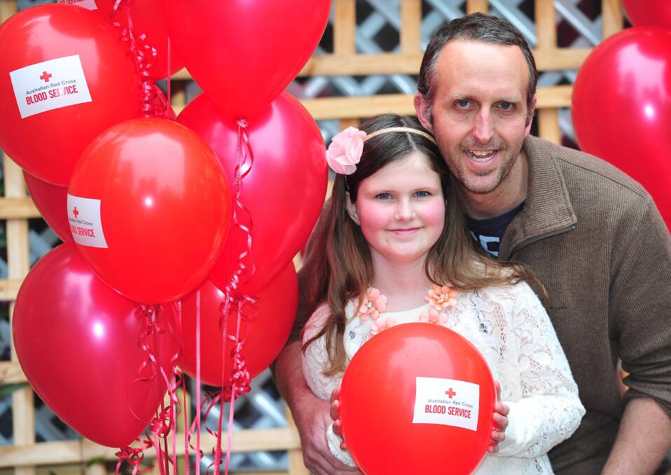 Saving lives: Zoe Roberts with her Dad, Adam Roberts, celebrate the efforts of Wagga blood donors on Saturday. Picture: Kieren L Tilly.