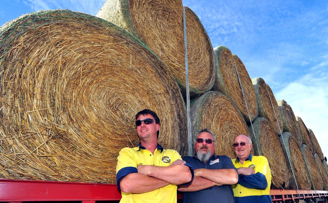 Big trip: Mitch Quade, Stephen Smith and Keith Montgomery of Riverina Plant Operators School prepare to leave Wagga to join the Burrumbuttock Hay Runners to deliver hay to Ilfracombe. Picture: Kieren L. Tilly.