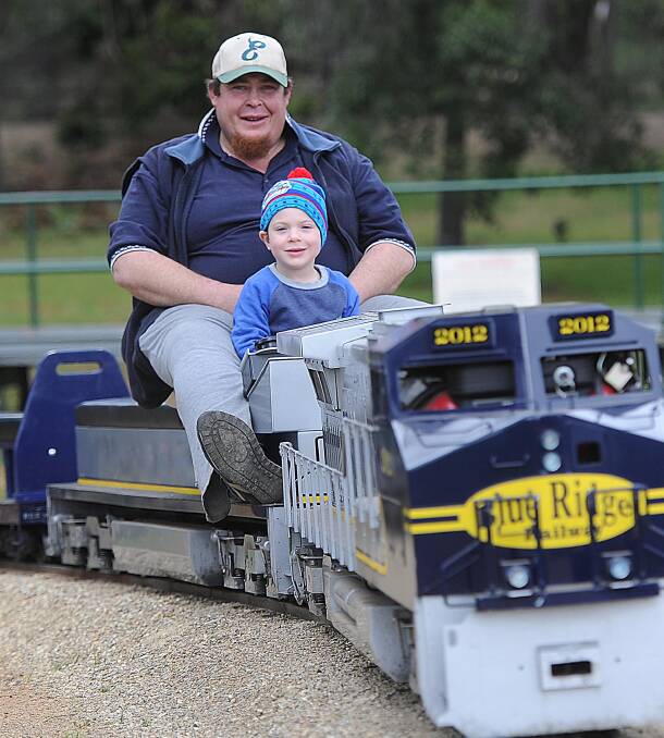 ALL ABOARD: Wagga Miniature Railway engine driver Richard James takes his four-year-old son Shaye for a spin around the tracks. Picture: Laura Hardwick