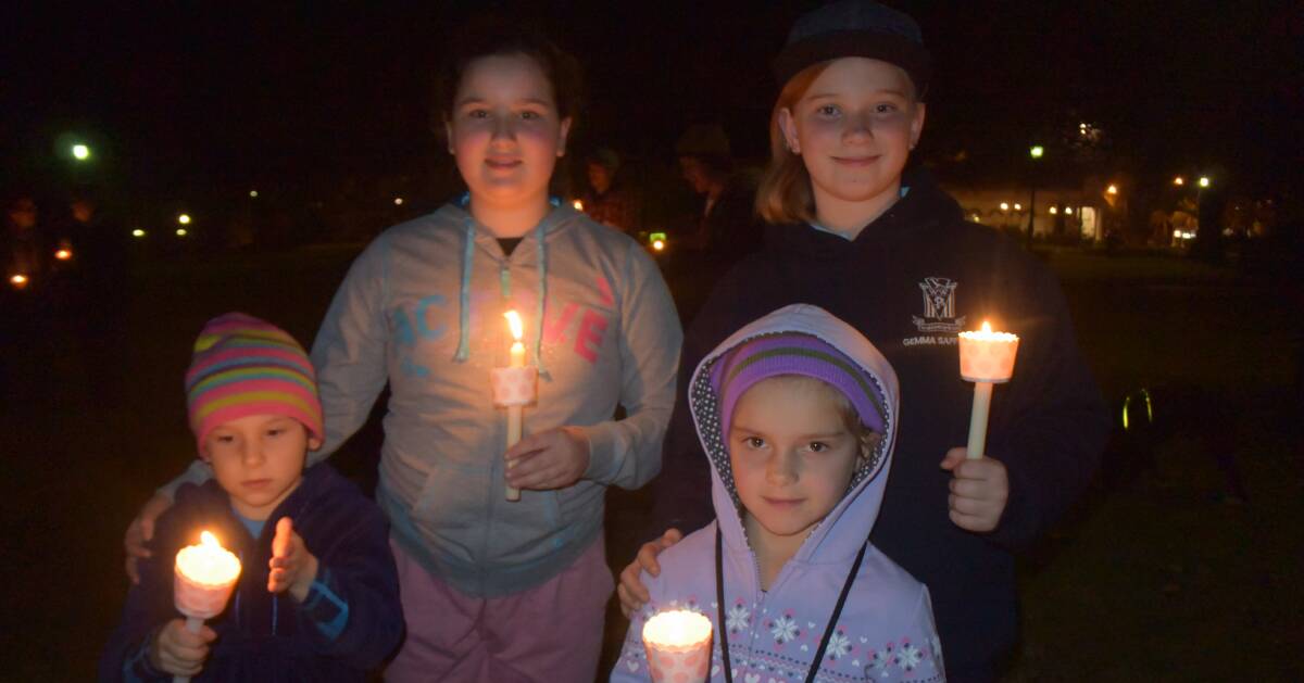 LIGHTING UP: Samson Taylor-Harpey, Ella Taylor-Harpey, Isabella Taylor-Harpey and Gemma Saffery were among the 100-strong crowd at Thursday night's vigil.